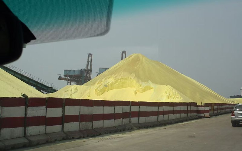 Industrial sulphur stockyard — wide-angle site view