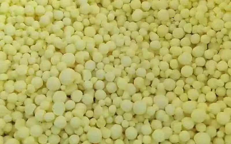 Bright yellow sulphur granules — pure material texture